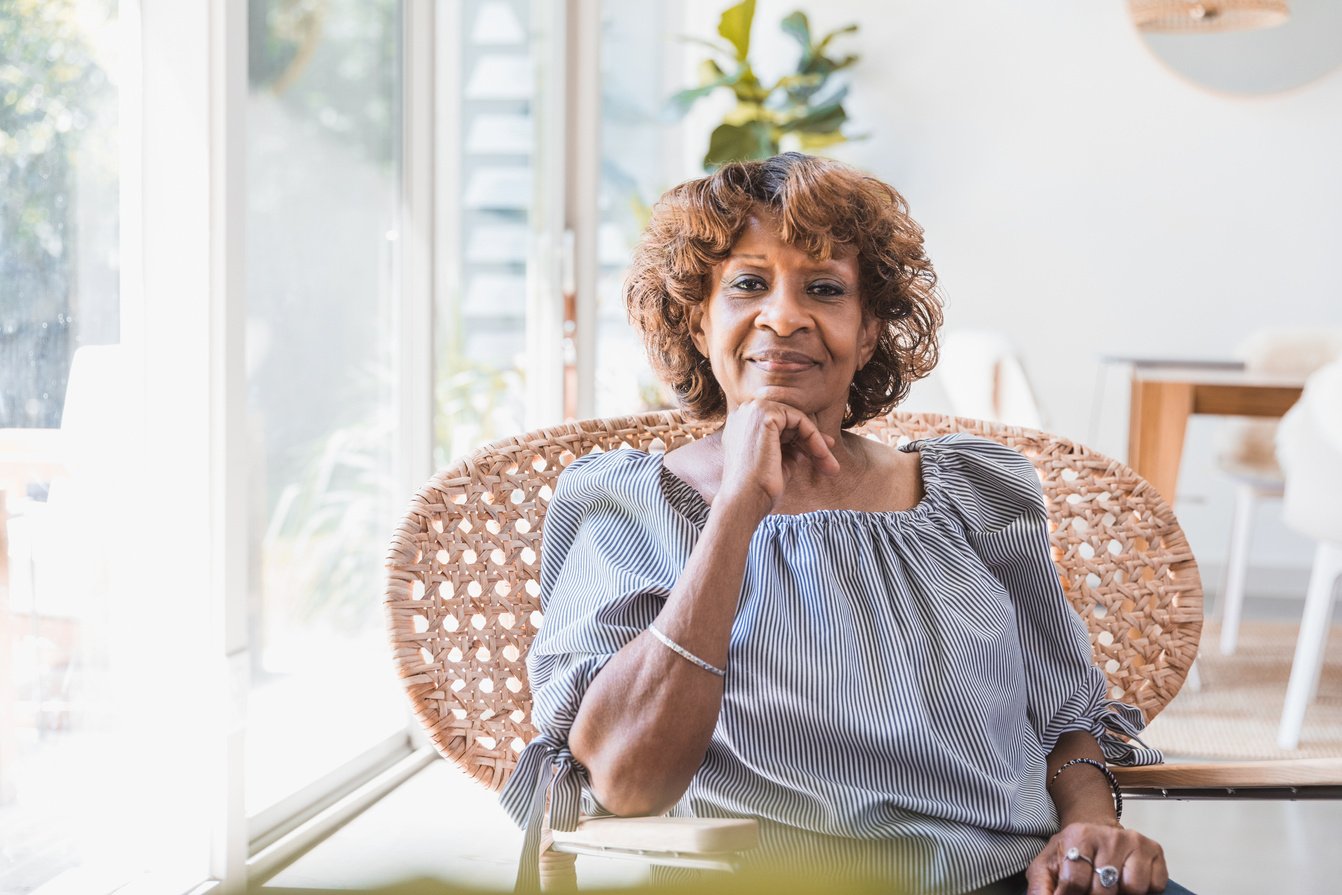 Confident, independent senior woman sitting in living room at home